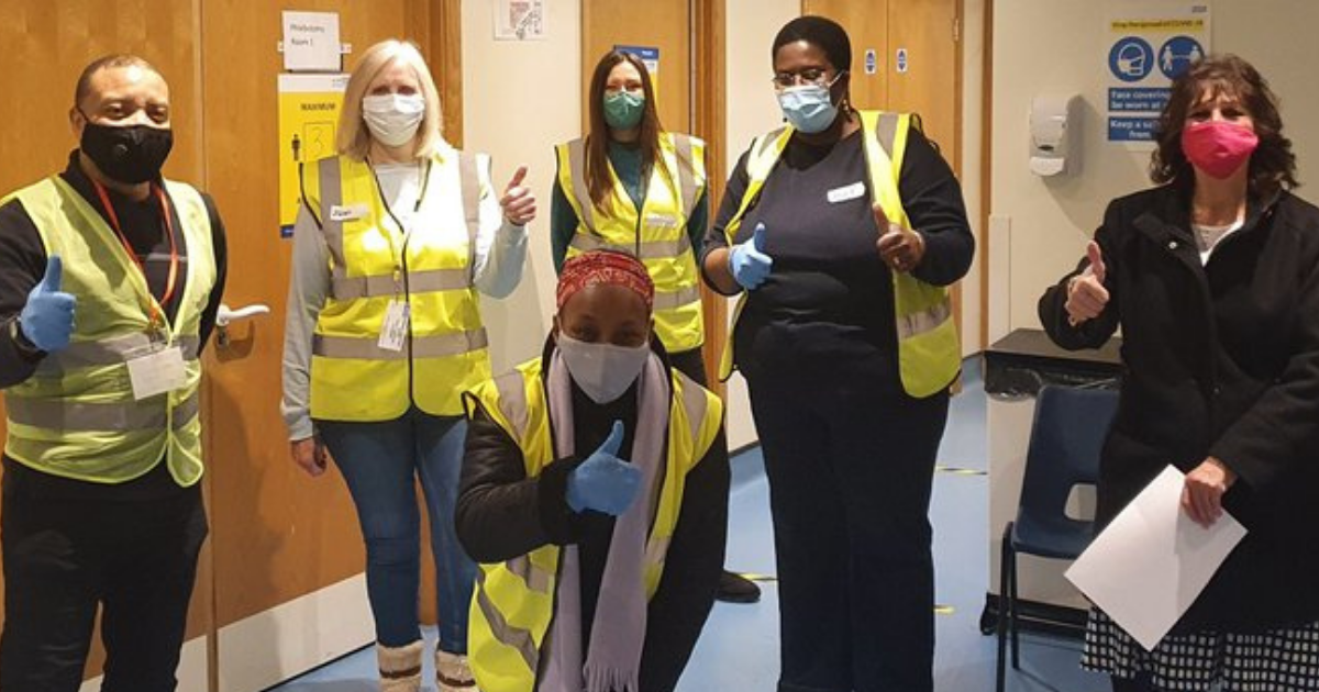 Havering VC Volunteers standing and giving a thumbs up wearing gloves and face-masks.